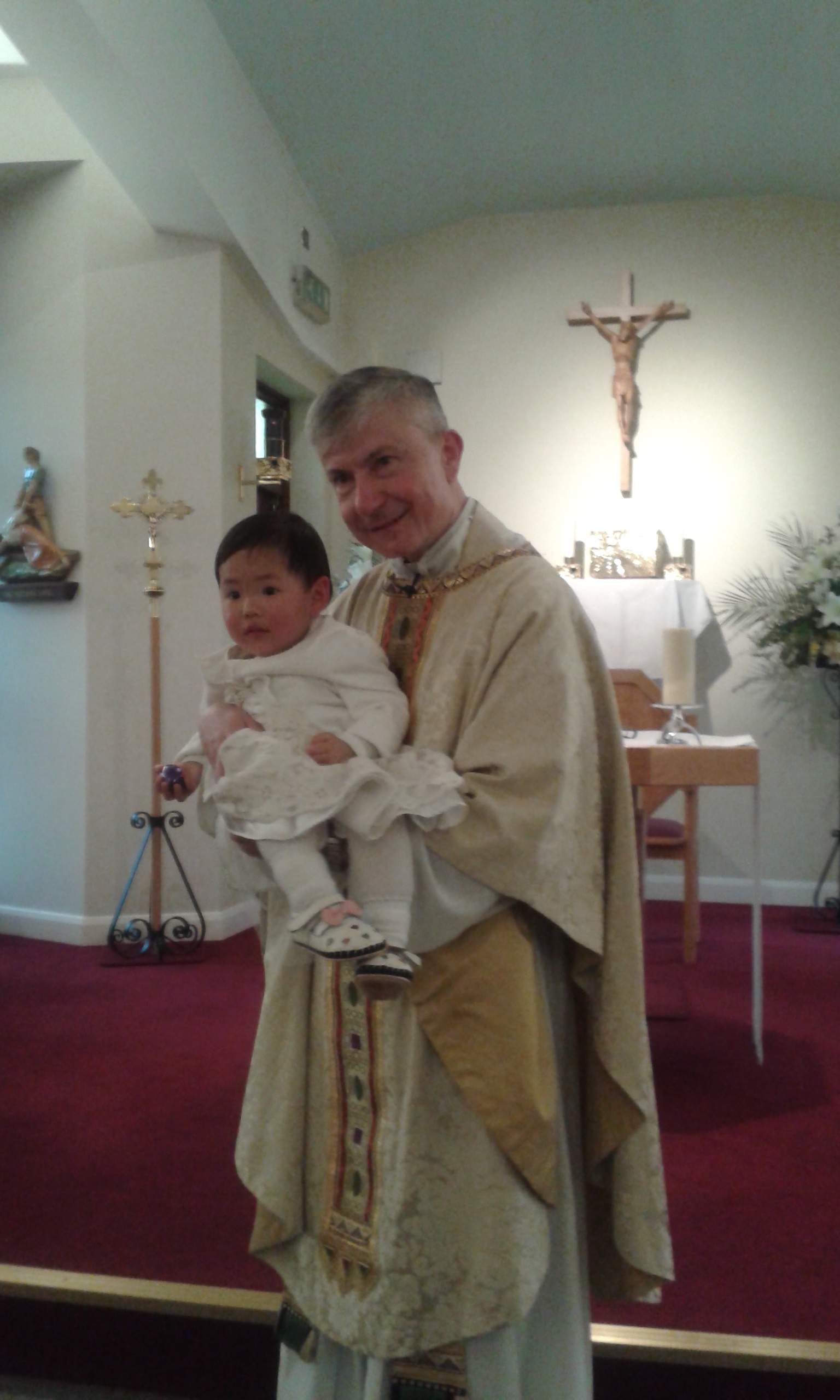 Fr Sean holding the baby (Jay-cee)